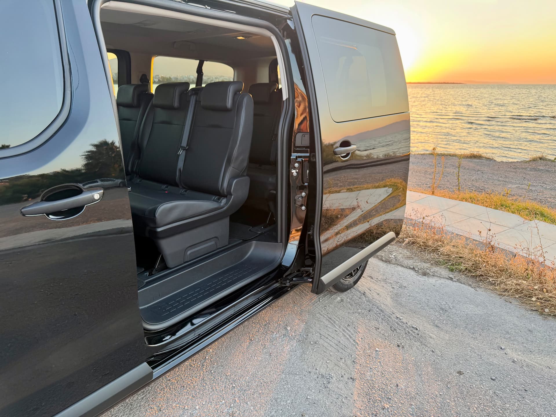Side door open showing the van interior at sunset